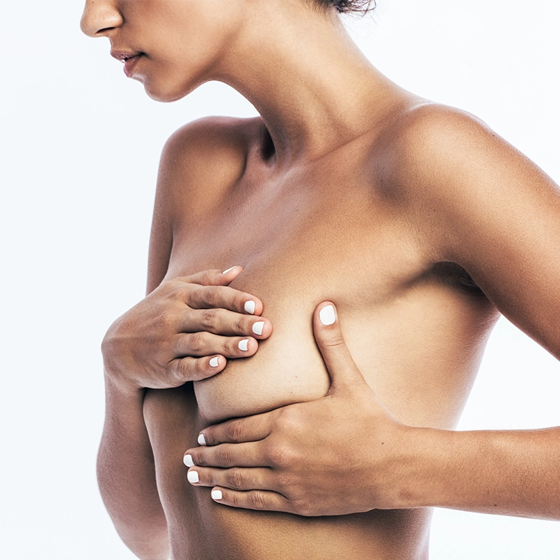 Image of a woman holding breast to reflect breast reconstruction for breast cancer. Photo for Marquis Plastic Surgery, Coral Gables, Miami, West Palm Beach, Florida.